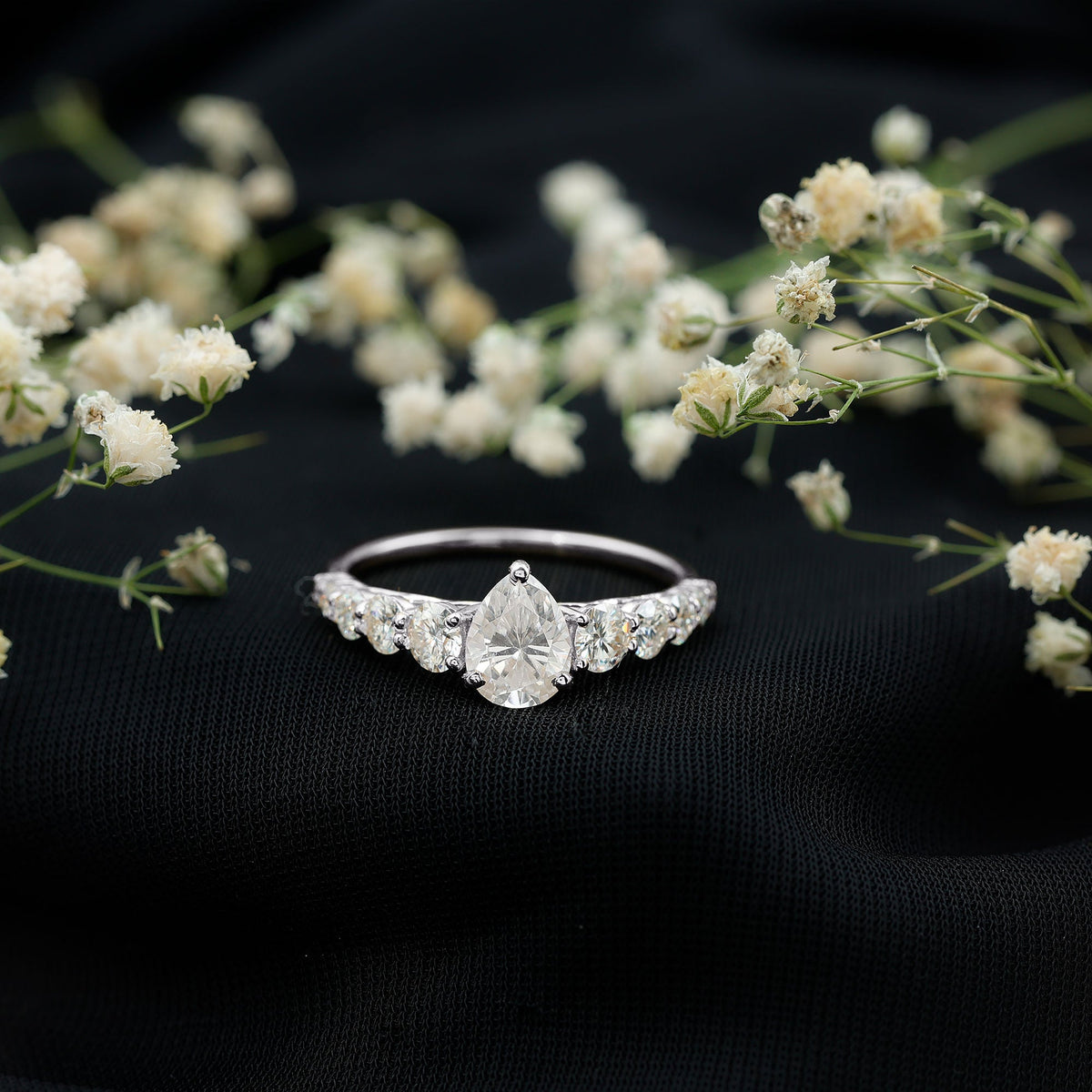 Rosec Jewels Perfect Pear Moissanite Engagement Ring with a unique pear-shaped gemstone and elegant band design.