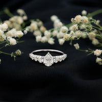 Rosec Jewels Perfect Pear Moissanite Engagement Ring with a unique pear-shaped gemstone and elegant band design.
