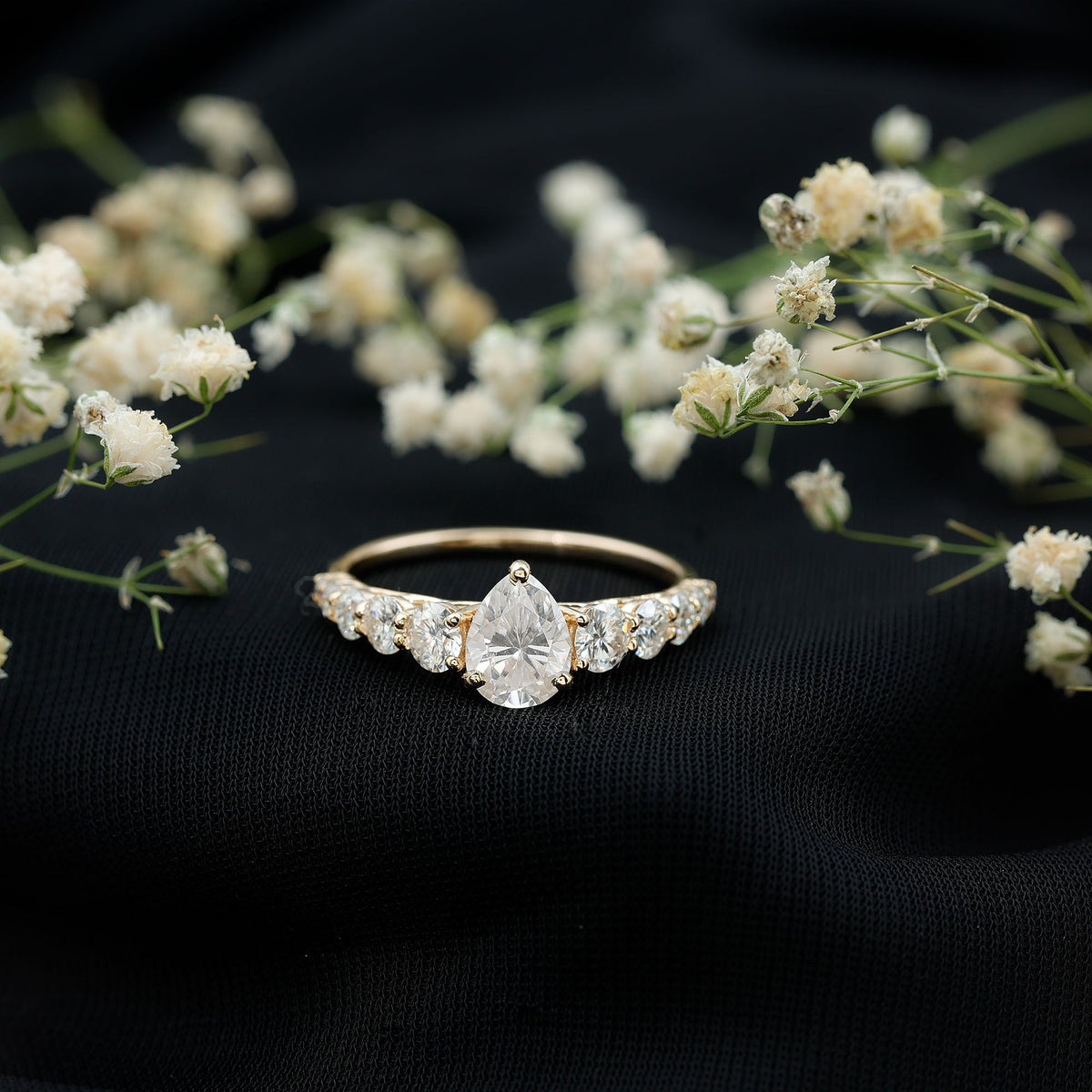 Rosec Jewels Perfect Pear Moissanite engagement ring showcasing a pear-shaped center stone and elegant band.