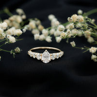 Rosec Jewels Perfect Pear Moissanite engagement ring showcasing a pear-shaped center stone and elegant band.