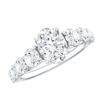 Oval cut moissanite side stone engagement ring by Rosec Jewels featuring a 1.2 carat center stone and elegant band design.