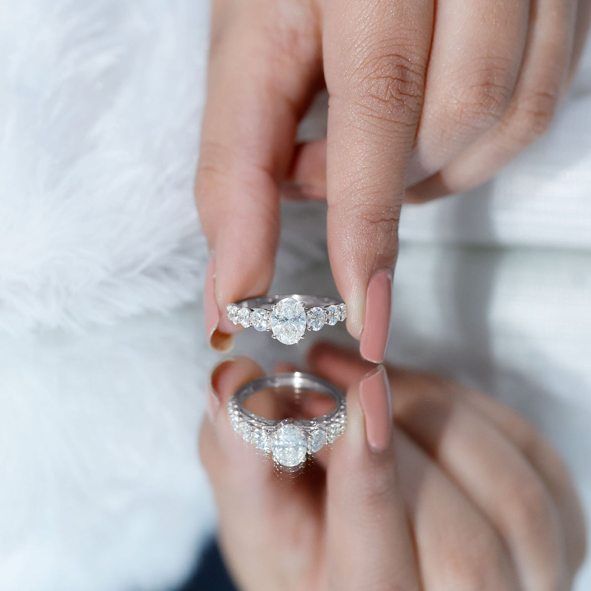 Oval cut 1.2 carat moissanite side stone engagement ring from Rosec Jewels featuring a polished silver band and elegant design.