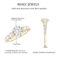 Oval cut moissanite side stone engagement ring with 1.2 carats, featuring a silver band and intricate design details.