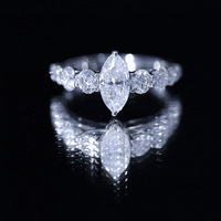 Marquise moissanite engagement ring with side stones from Rosec Jewels, featuring a sparkling central stone and elegant band.