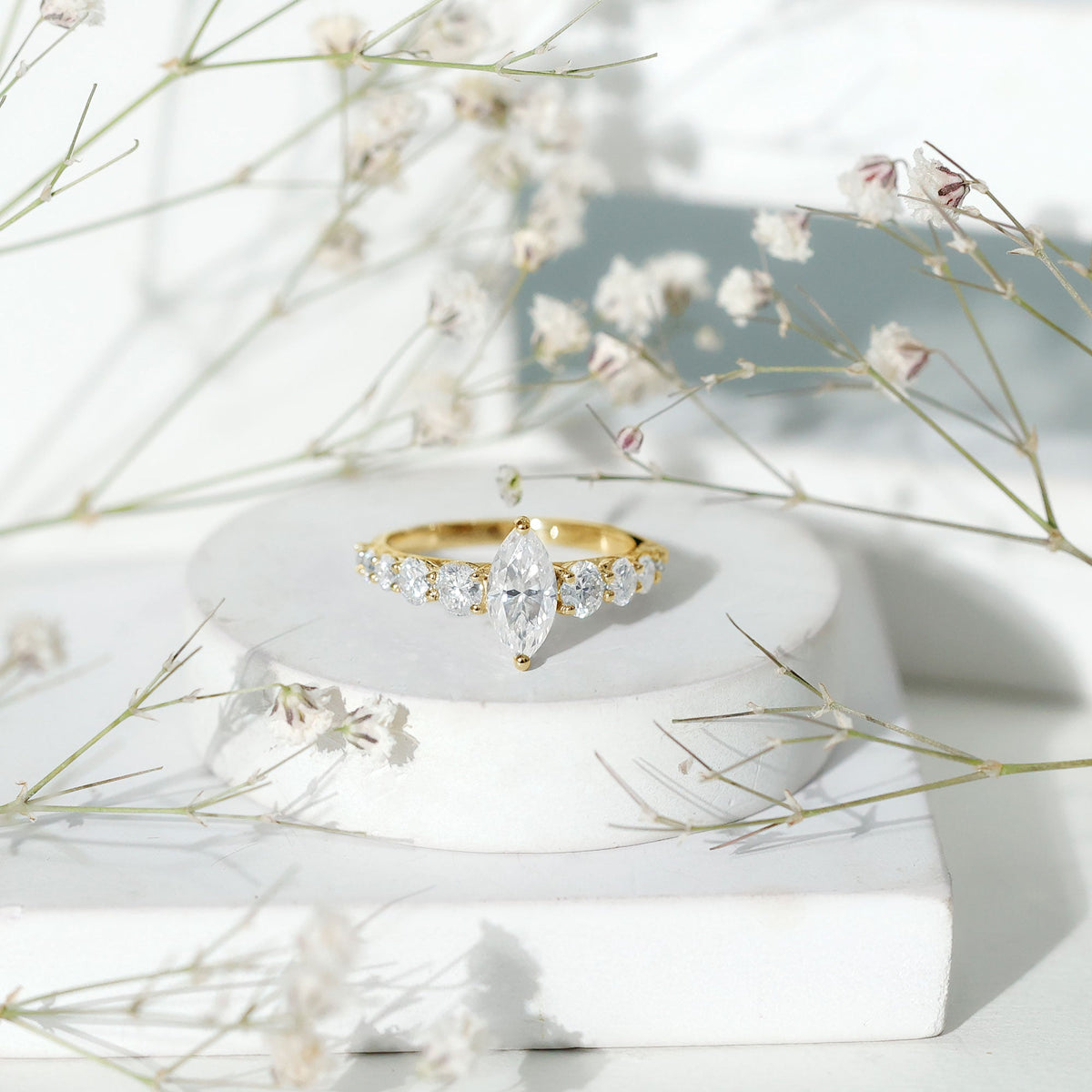 Marquise moissanite engagement ring with side stones, featuring a sparkling center stone and elegant band from Rosec Jewels.