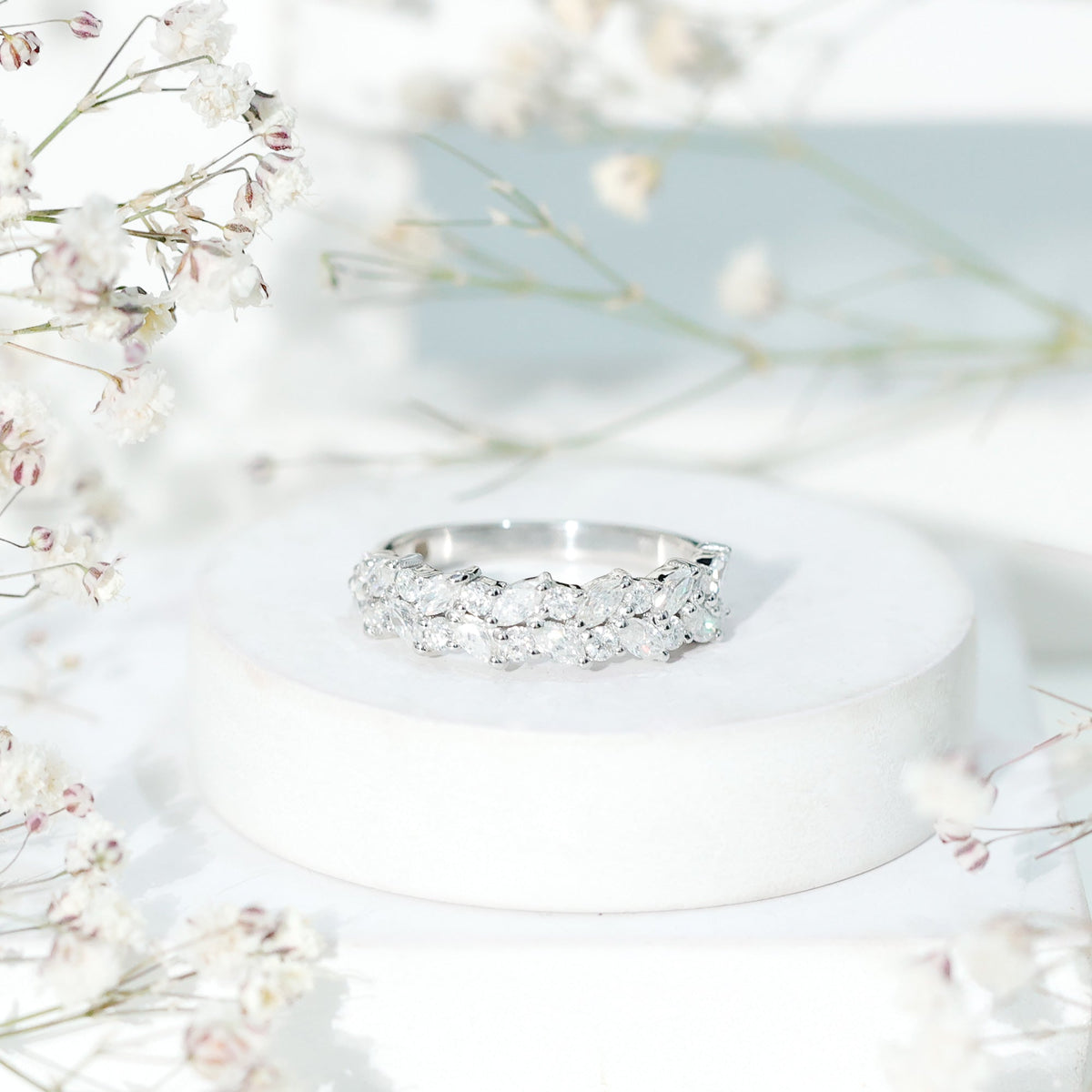 Rosec Jewels certified moissanite cluster eternity ring with sparkling gemstone cluster and sleek band design.