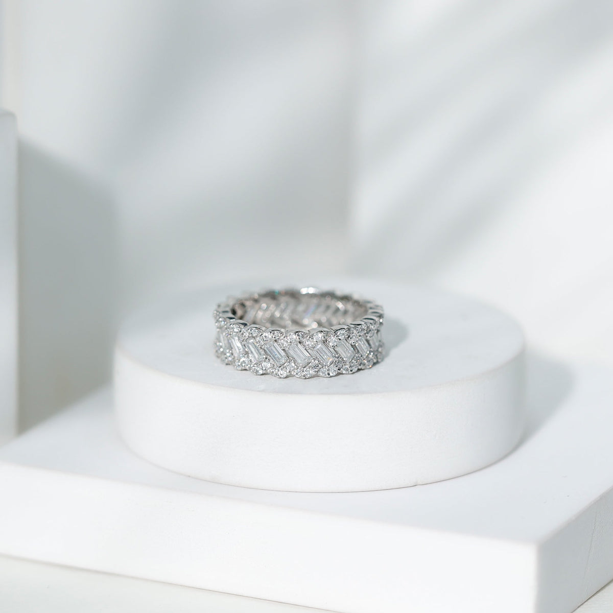 Rosec Jewels moissanite braided wedding band featuring a baguette and round cut stones, crafted in elegant ring design.