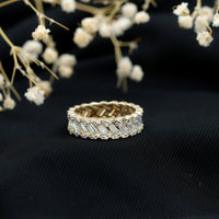 Rosec Jewels moissanite braided wedding band featuring a baguette and round cut gemstones in a polished ring design.