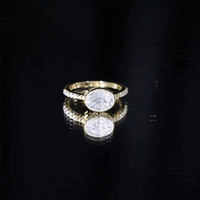 Yellow gold moissanite east-west engagement ring in bezel setting by Rosec Jewels, showcasing a central sparkling moissanite gemstone.