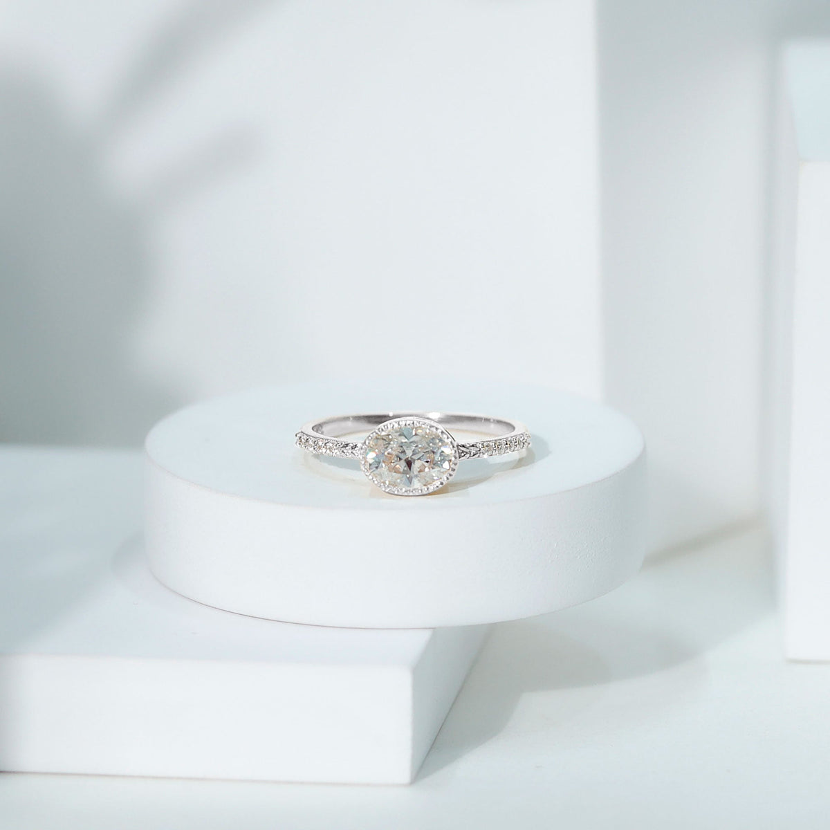 Moissanite east-west engagement ring by Rosec Jewels featuring a bezel-set center stone on a sleek band.