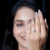 Moissanite east-west engagement ring in bezel setting by Rosec Jewels, featuring a sleek design and sparkling gemstone.