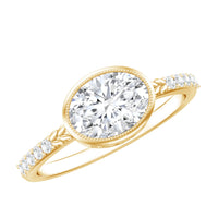 Moissanite east-west engagement ring in bezel setting by Rosec Jewels, showcasing a sleek band with a central sparkling moissanite stone.