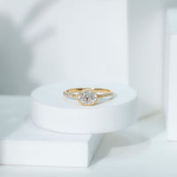 Rosec Jewels Moissanite east-west engagement ring with bezel setting, showcasing a sparkling central stone in a sleek, modern design.