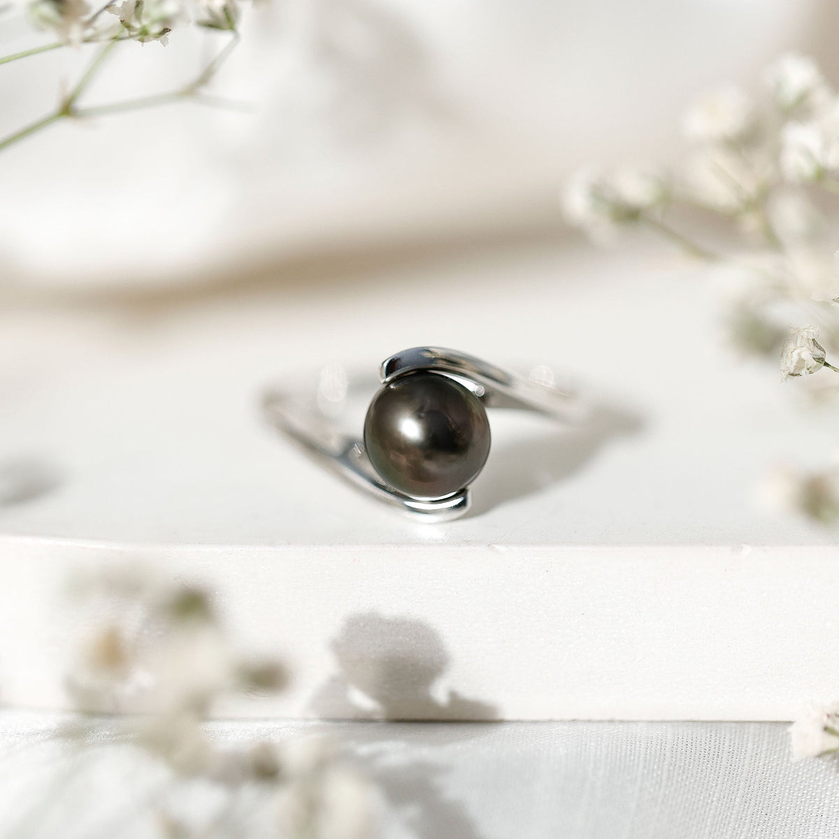 Tahitian black pearl solitaire bypass engagement ring by Rosec Jewels with elegant silver band and polished finish.