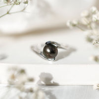 Tahitian black pearl solitaire bypass engagement ring by Rosec Jewels with elegant silver band and polished finish.