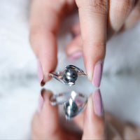 Tahitian black pearl solitaire bypass engagement ring by Rosec Jewels, featuring a black pearl set in a sleek bypass band.