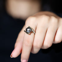 Tahitian black pearl solitaire bypass engagement ring by Rosec Jewels showcasing a black pearl set on a silver bypass band.