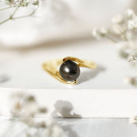 Tahitian black pearl solitaire bypass engagement ring from Rosec Jewels featuring a black pearl set on a sleek silver band.