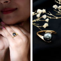 Tahitian black pearl solitaire bypass engagement ring by Rosec Jewels, featuring a sleek silver band and a prominent black pearl centerpiece.