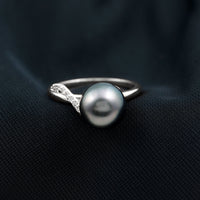 8 carat Tahitian pearl solitaire engagement ring with diamond accents, featuring a sleek band and elegant design.