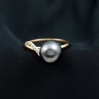 8 carat Tahitian pearl solitaire engagement ring with diamond accent by Rosec Jewels, featuring a prominent dark, lustrous pearl and elegant band.