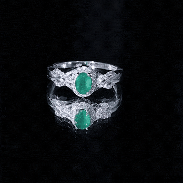 Rosec Jewels emerald oval engagement ring with diamond halo, featuring yellow band and intricate design details.