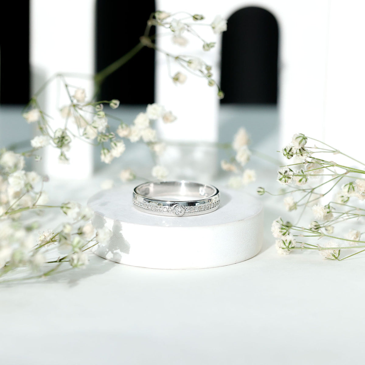 Bezel set diamond unisex wedding band from Rosec Jewels, close-up of sleek gold ring with sparkling diamond accents.