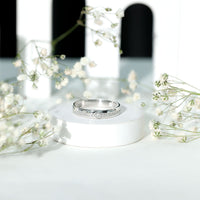 Bezel set diamond unisex wedding band from Rosec Jewels, close-up of sleek gold ring with sparkling diamond accents.