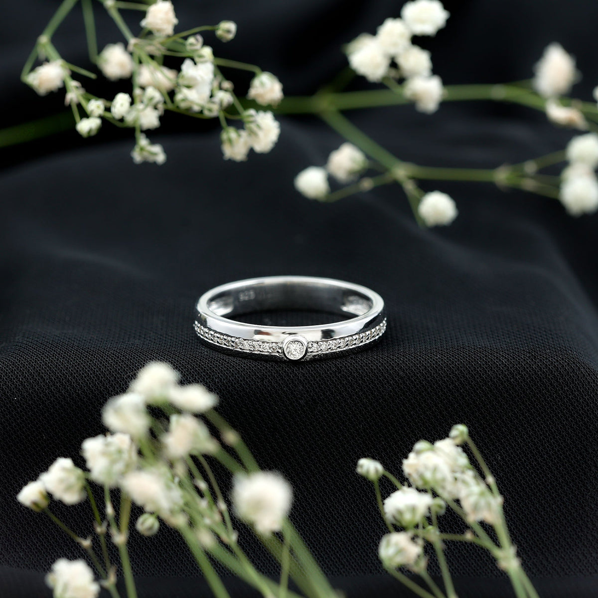 Bezel set diamond unisex wedding band from Rosec Jewels featuring a sleek silver ring with a prominent diamond setting.