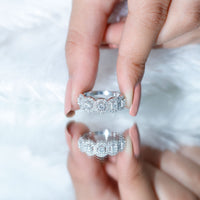 Round cut moissanite halo band ring by Rosec Jewels featuring a classic design with sparkling center stone and intricate band detailing.