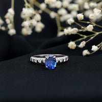 Oval lab-grown blue sapphire engagement ring with diamonds by Rosec Jewels, showcasing a 1.5-carat gemstone and elegant design.