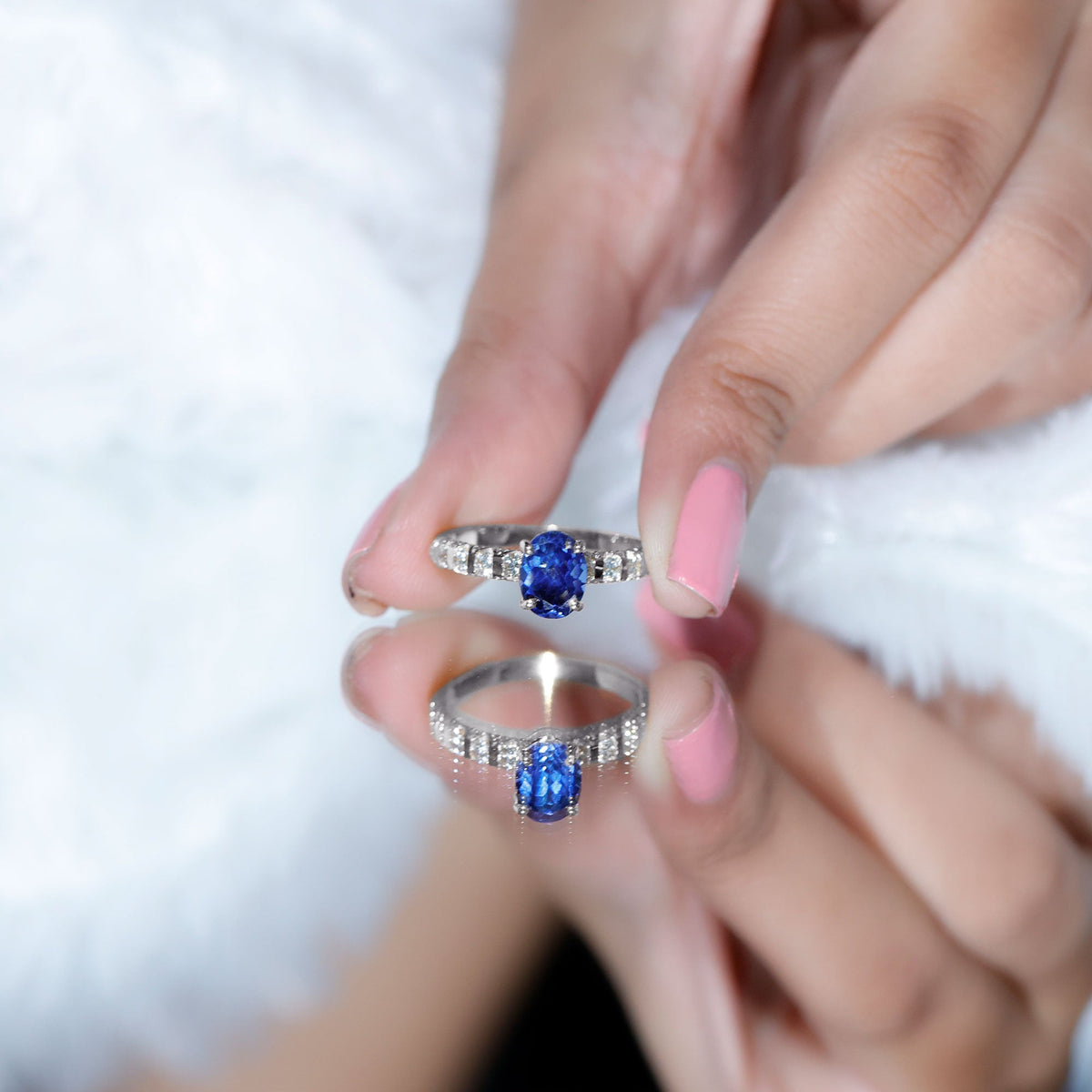 Oval lab-grown blue sapphire engagement ring with diamonds, set in a rose gold band, from Rosec Jewels.
