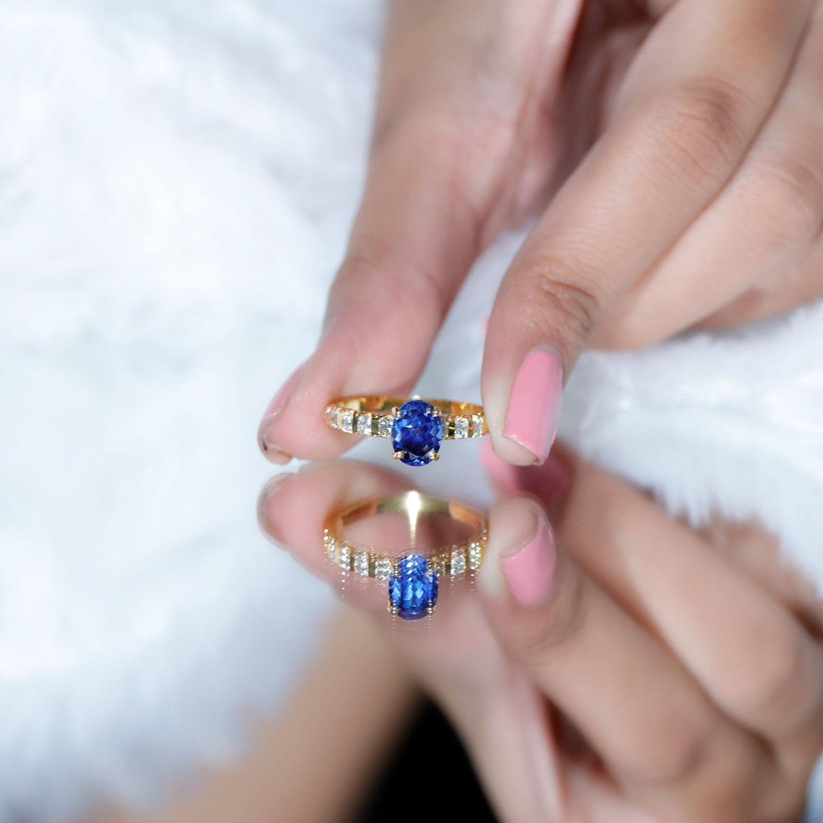 Oval lab-grown blue sapphire engagement ring with diamond accents by Rosec Jewels, showcasing the detailed silver band.
