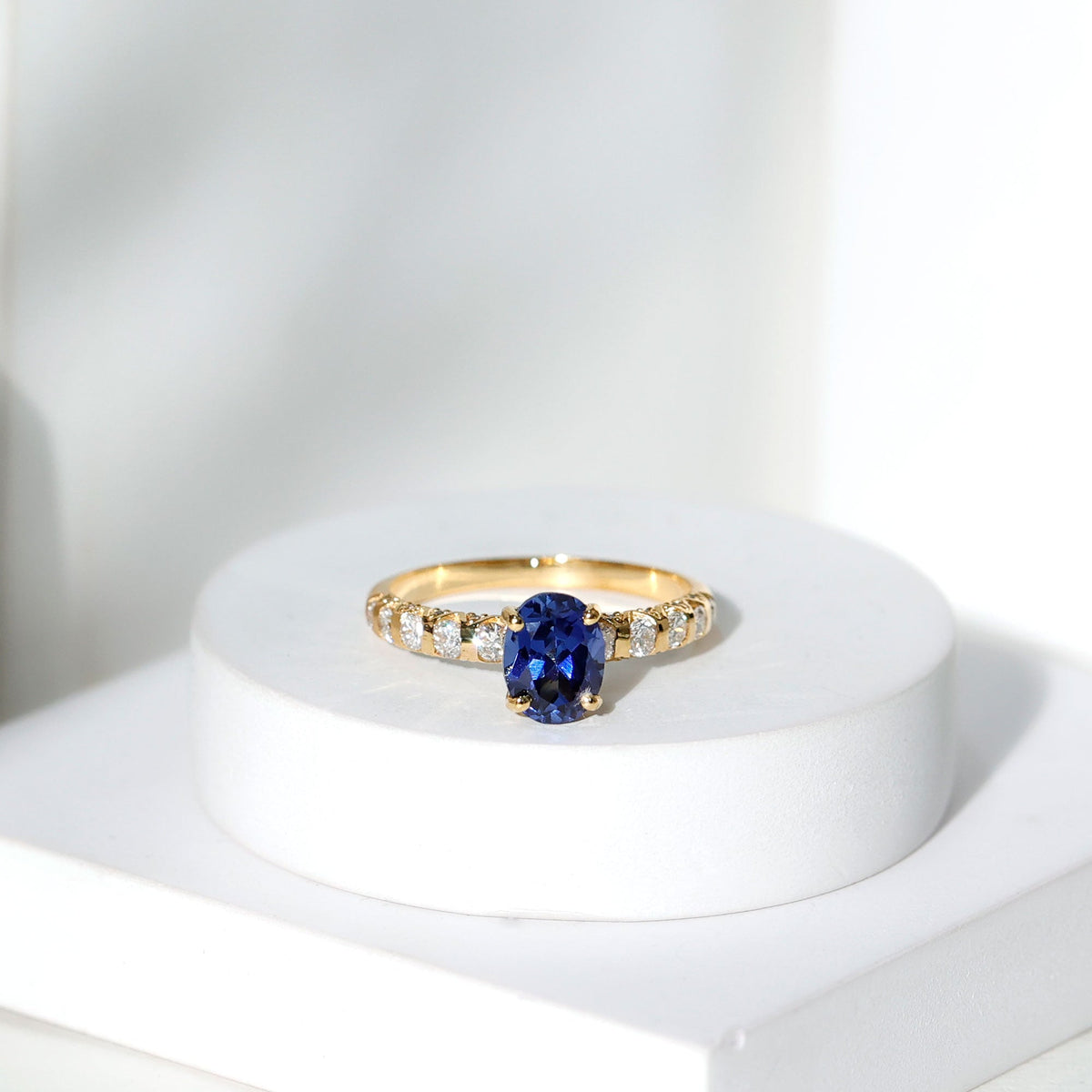 Certified 1.5 Carat oval lab-grown blue sapphire engagement ring with diamonds by Rosec Jewels, showcasing the detailed design.