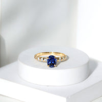 Certified 1.5 Carat oval lab-grown blue sapphire engagement ring with diamonds by Rosec Jewels, showcasing the detailed design.
