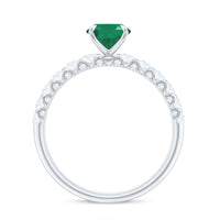 Natural 6x8mm emerald oval engagement ring from Rosec Jewels with diamond side stones and sterling silver band.