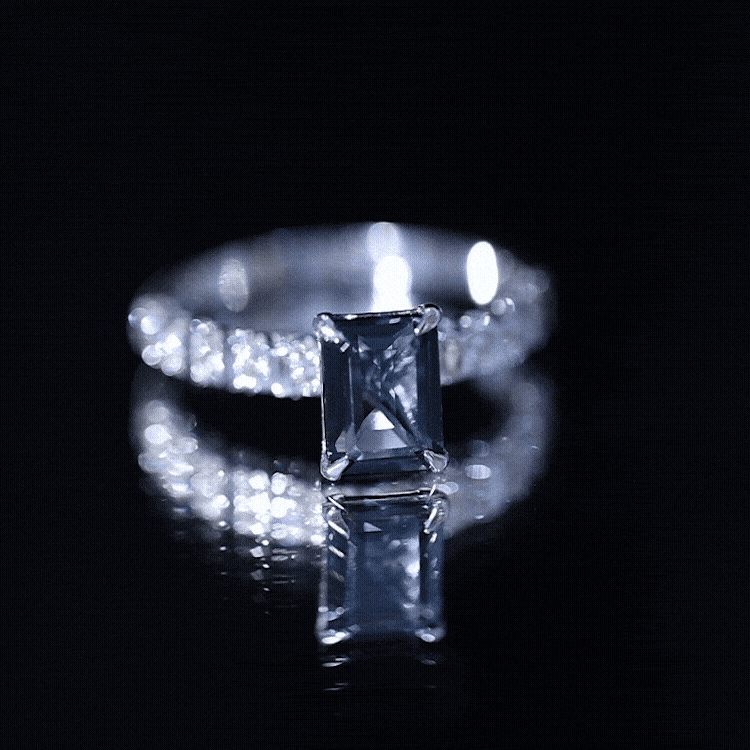 Emerald cut London Blue Topaz engagement ring with diamond side stones by Rosec Jewels, showcasing the vibrant blue gemstone and sparkling accents.
