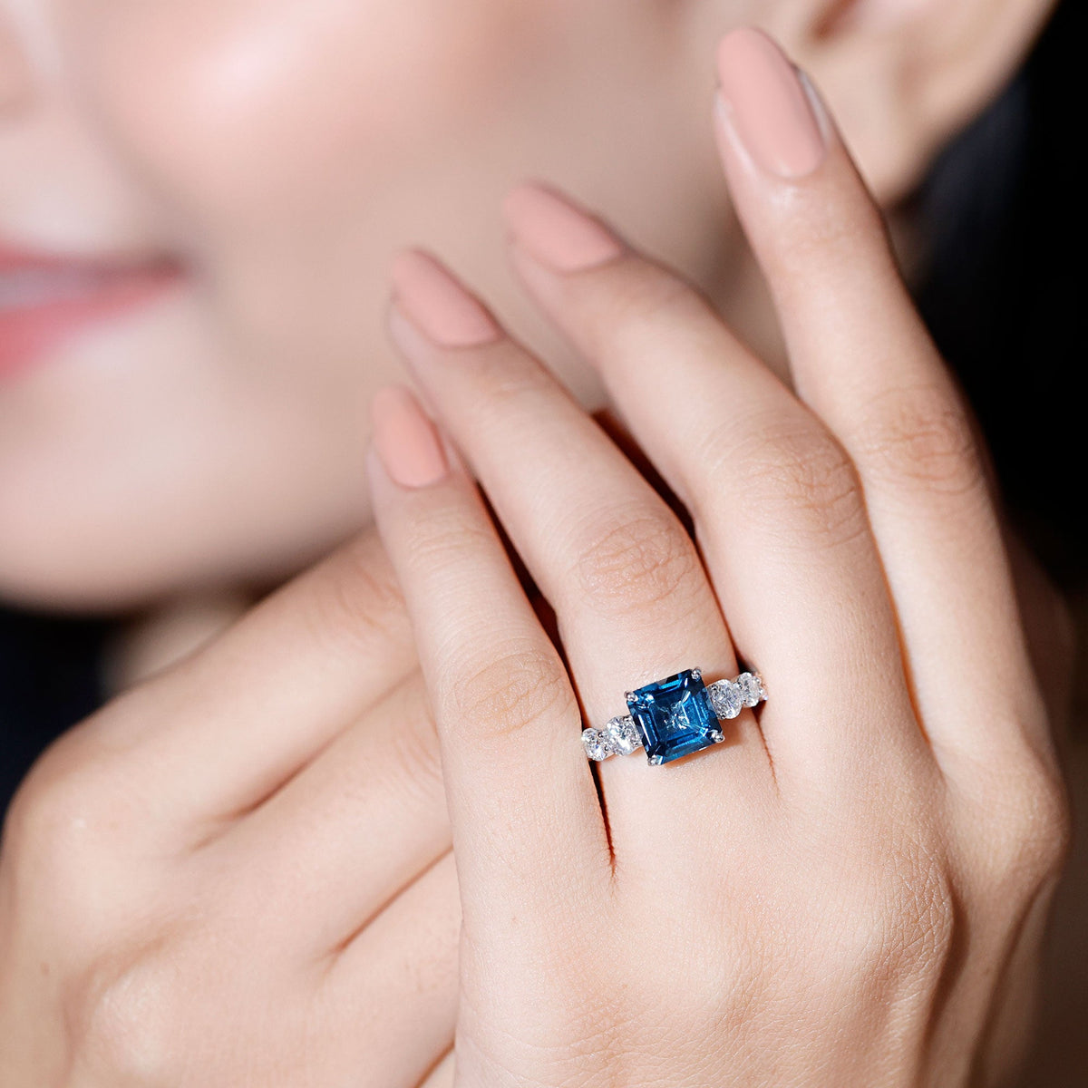 Asscher cut 3 carat London Blue Topaz solitaire engagement ring with moissanite accents, showcasing a sparkling gemstone and elegant band.
