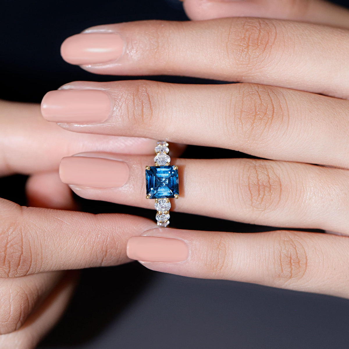 Asscher cut 3 carat London Blue Topaz solitaire engagement ring with moissanite accents, featuring a silver band.