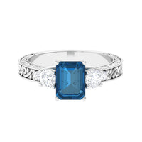Rosec Jewels 6x8mm London Blue Topaz statement ring with emerald cut and engraved shank, showcasing a vibrant blue gemstone.