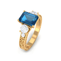 Rosec Jewels 6x8mm London Blue Topaz statement ring with emerald cut and engraved shank, showcasing vibrant blue gemstone and detailed band.