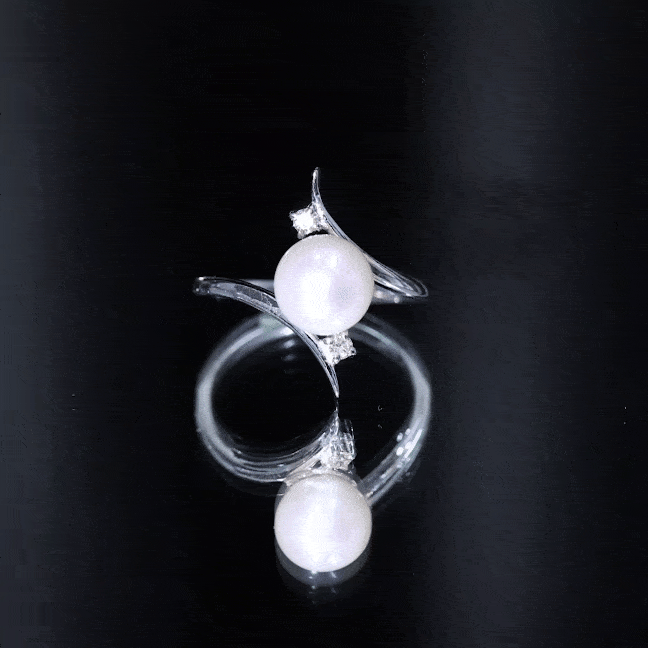 Freshwater pearl engagement ring with diamond bypass shank by Rosec Jewels, showcasing a 7.4-carat pearl and sparkling accents.