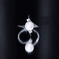 Freshwater pearl engagement ring with diamond bypass shank by Rosec Jewels, showcasing a 7.4-carat pearl and sparkling accents.