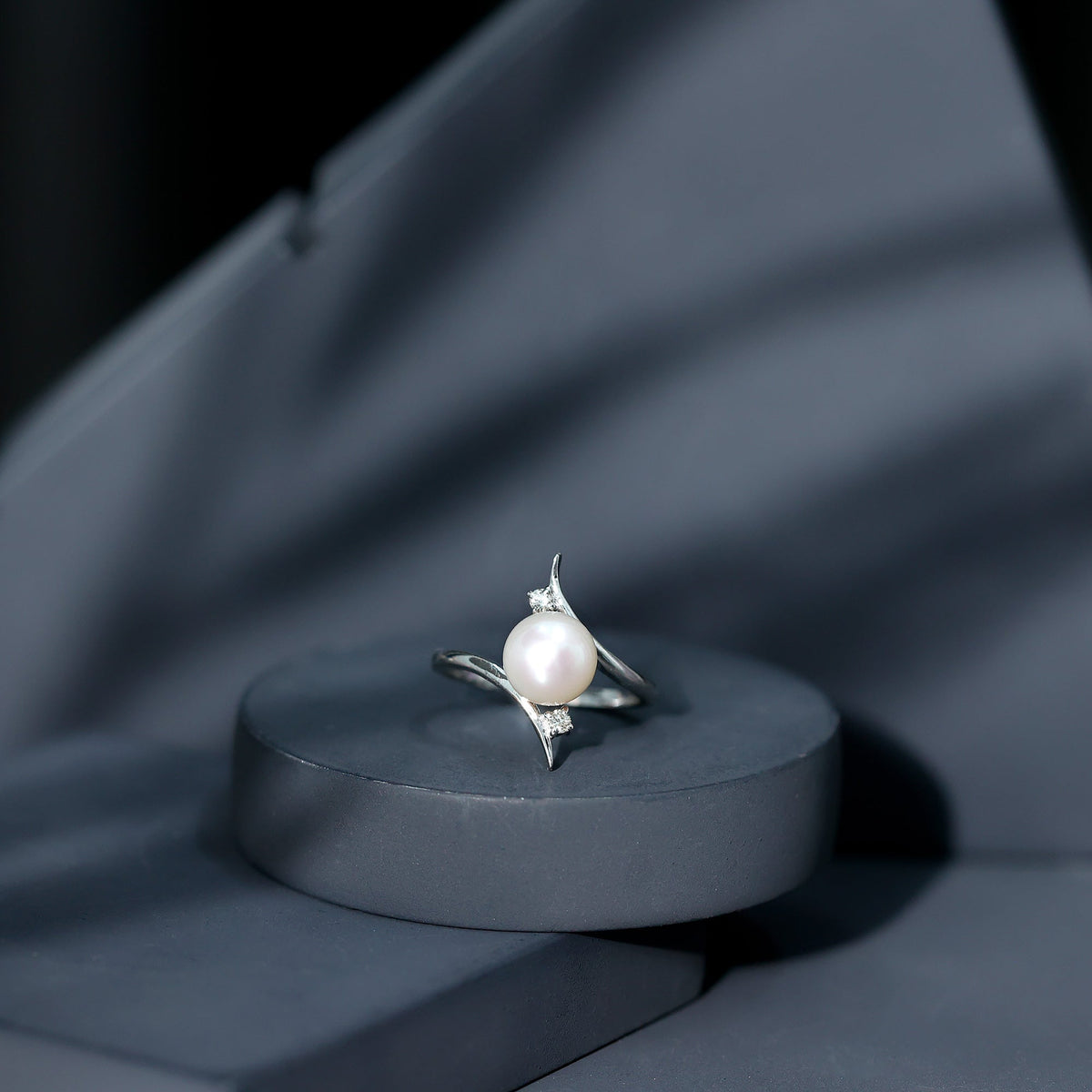 Rosec Jewels cultured 7.4 carat freshwater pearl engagement ring with diamond bypass shank, showcasing elegant jewelry design.