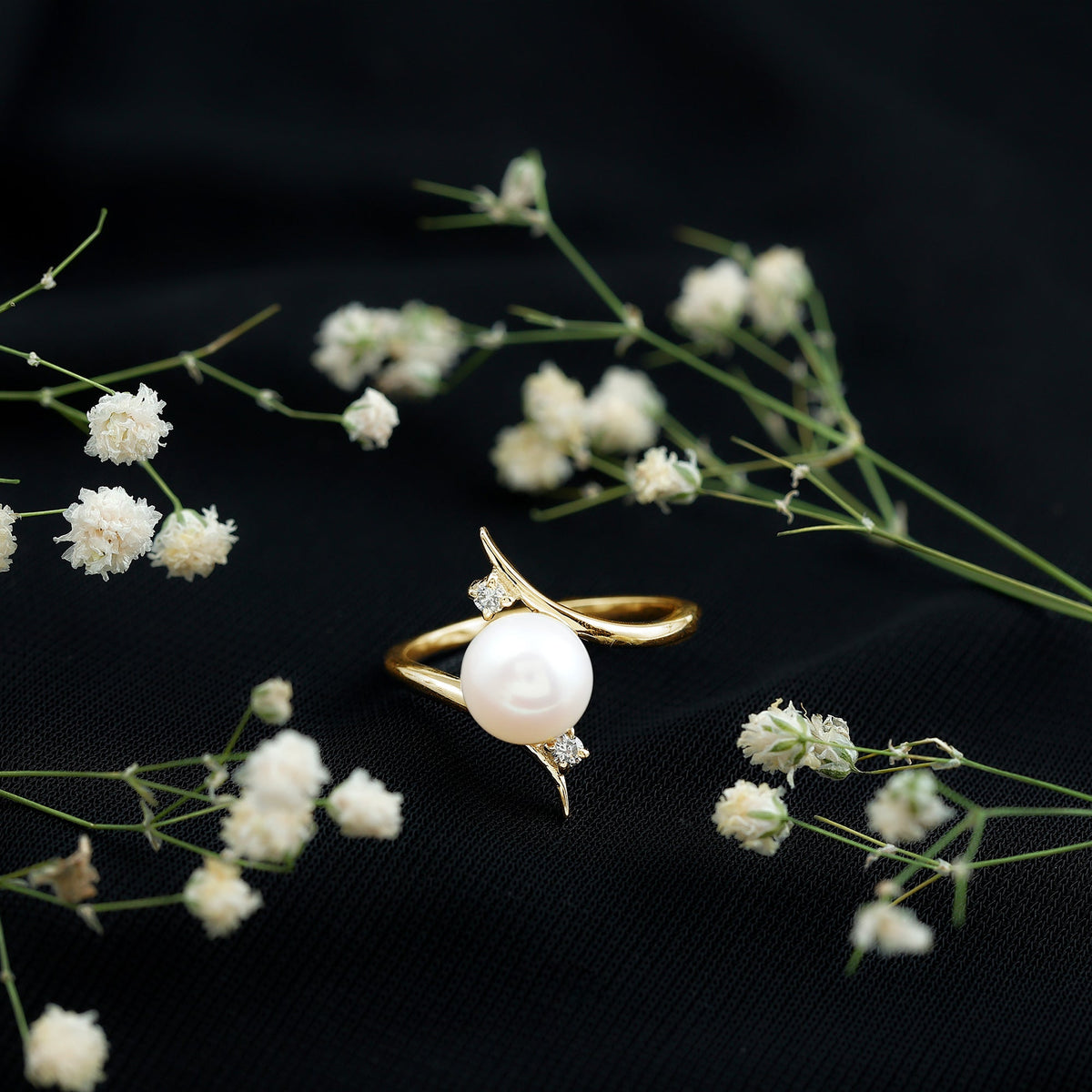 Rosec Jewels cultured 7.4 carat freshwater pearl engagement ring with diamond bypass shank, showcasing elegant design and sparkling accents.