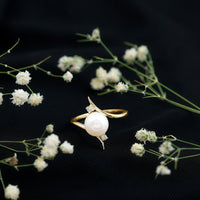 Rosec Jewels cultured 7.4 carat freshwater pearl engagement ring with diamond bypass shank, showcasing elegant design and sparkling accents.