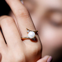 Cultured 7.4 carat freshwater pearl engagement ring with diamond bypass shank, featuring Rosec Jewels logo design and intricate band details.