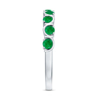 Stackable green emerald half eternity ring by Rosec Jewels featuring natural green emeralds and a sleek, elegant band.