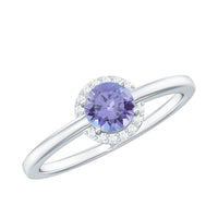 Natural Tanzanite engagement ring with diamond halo from Rosec Jewels, featuring a central tanzanite gemstone surrounded by sparkling diamonds.