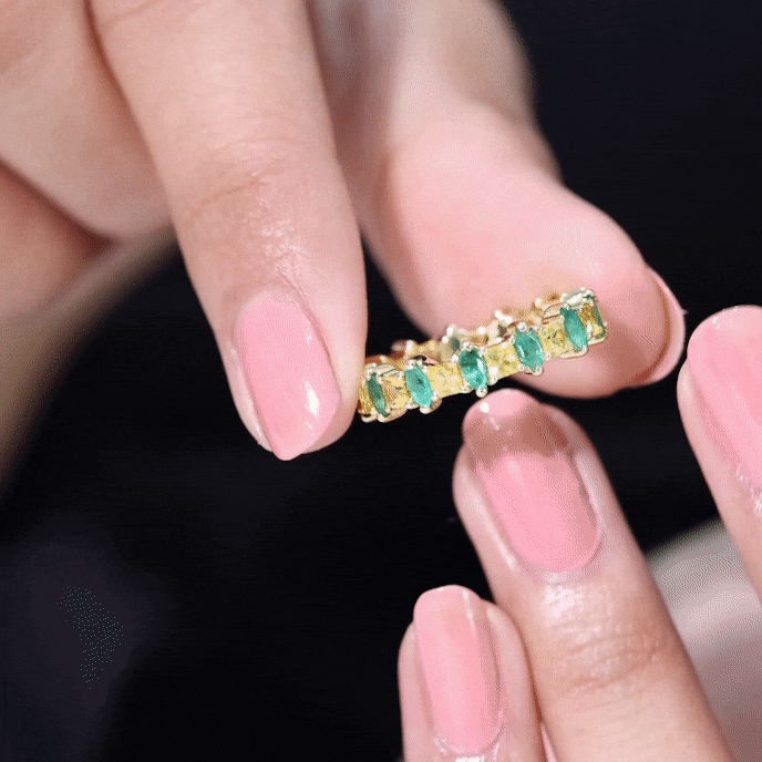 Yellow sapphire and emerald eternity wedding band by Rosec Jewels, showcasing a gold ring with alternating gemstones.